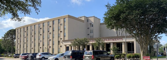 a large building with a parking lot in front of it