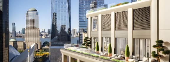 A model of a cityscape with a building featuring a green roof.