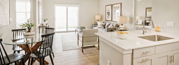 an open kitchen and living room with a dining room table and chairs at 44 West Luxury Living, Missouri