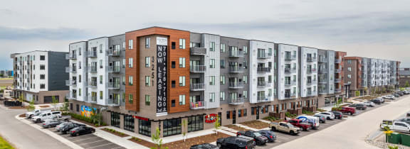 a large apartment building with cars parked in front of it at EagleRidge Plaza Residences, Fargo, ND, 58104