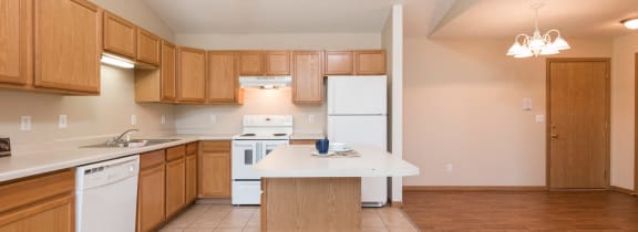 Bismarck, ND Sierra Ridge |a kitchen with white appliances and wooden cabinets