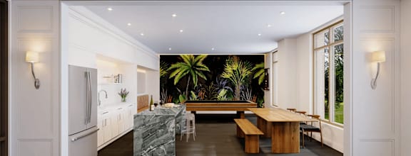 A modern kitchen with a marble island and a dining table set up.