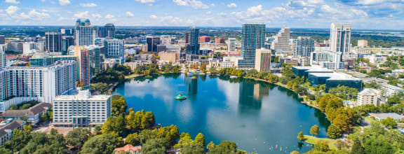 an aerial view of lake eola with the austin skyline in the background