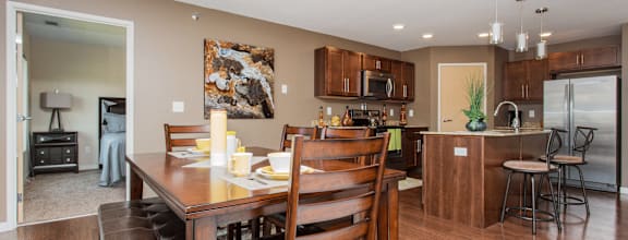 A modern dining room with a wooden table and chairs.