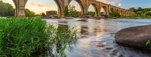 a train bridge over a river with water under it