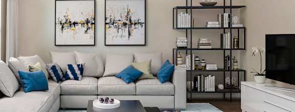 A modern living room with a white sofa, a coffee table, and two abstract paintings on the wall.