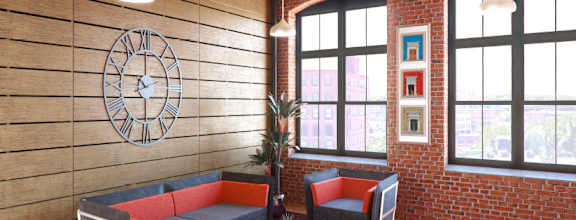 A living room with a couch, chair, and a clock on the wall.