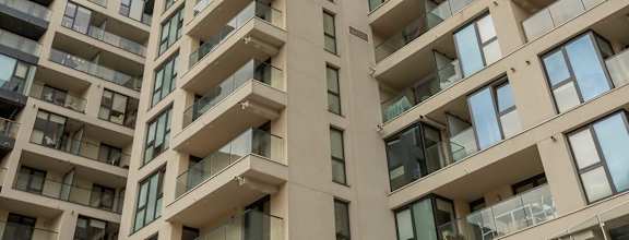 a large apartment building with balconies on the side of it