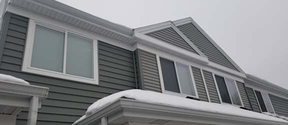 A house with a grey roof and white trim.