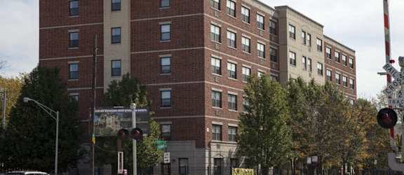 a large brick building on the corner of a street