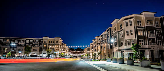 a city street at night with buildings and street lights