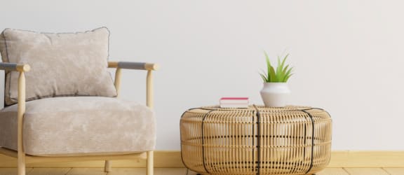 a room with a chair and a table with a plant on it