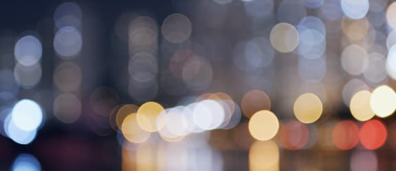 A blurry image of a city at night with lights.