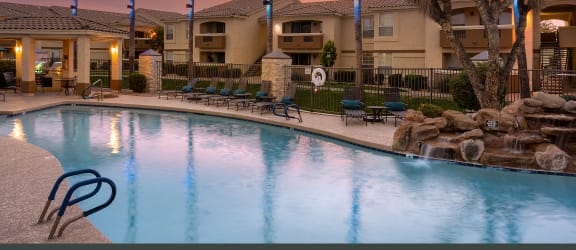 Resort-style swimming pool at dusk - Arrowhead Landing Apartments