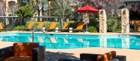 Pool with Lounge Chairs l Oak Brook Apartments in Rancho Cordova CA