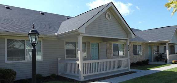 A house with a grey roof and a white porch.