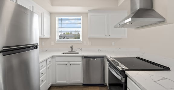a kitchen with a stove top oven next to a sink