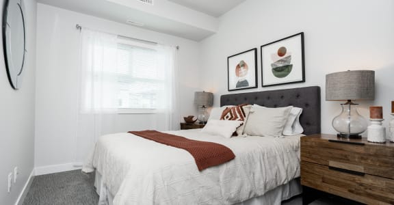 a bedroom with a large bed and two pictures on the wall