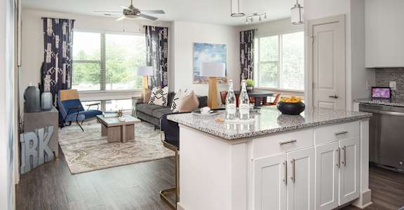 A modern kitchen with white cabinets and a large island.