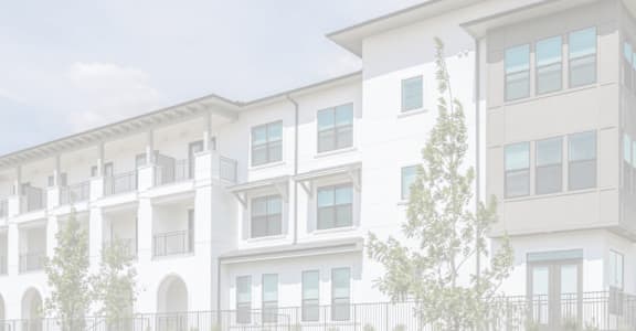 A white building with multiple balconies and windows.