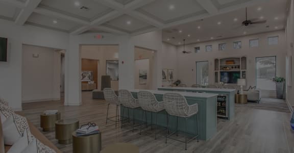 A spacious living room with a bar area and a television.