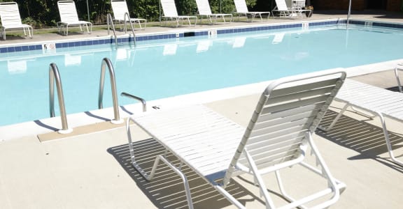 a swimming pool with chaise lounge chairs and a poolside umbrella at Ivy Hall Apartments*, Towson, 21204
