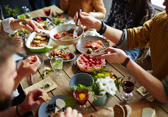 A group of people enjoying a meal together at a table.
