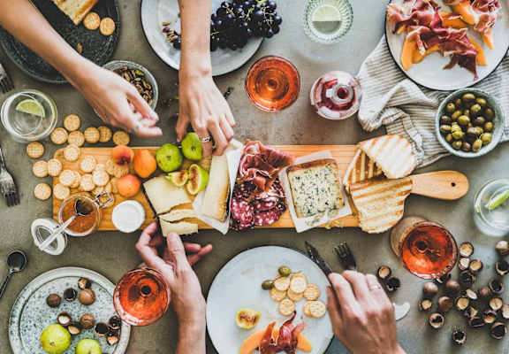 a tray of sandwiches on a table with fruit