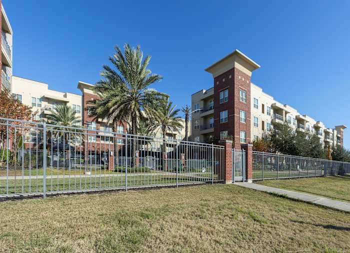 The entrance to the community with the apartment buildings behind