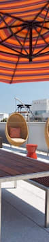 a rooftop patio with a table and chairs and an umbrella at 34 Berry, Brooklyn, New York