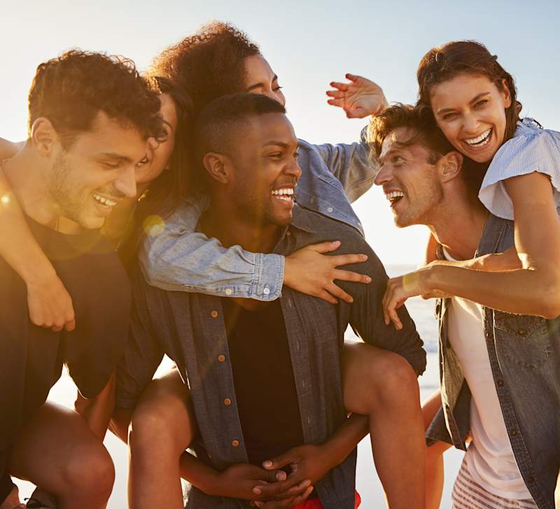 A group of friends huddled together outdoors, laughing