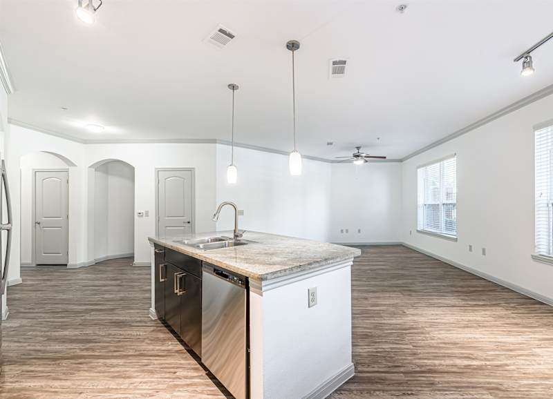 A kitchen counter running under a window