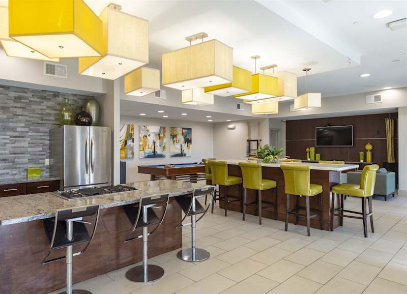 The community kitchen bar with yellow stools