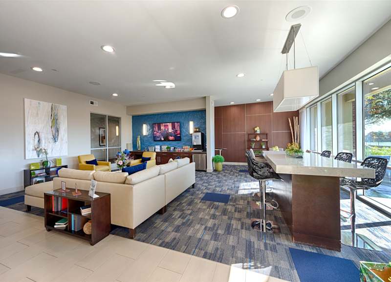 The resident lounge with a white sofa set against a blue accent wall
