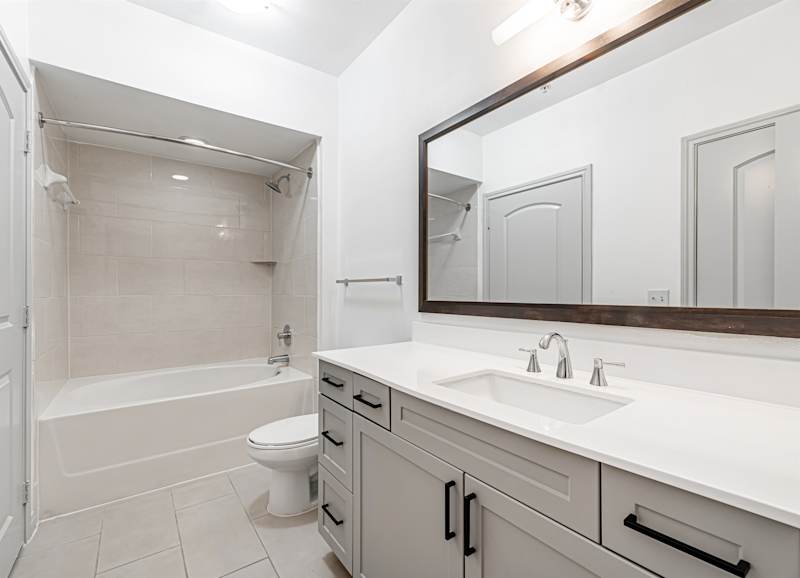 A bathroom with a toilet, sink and bathtub