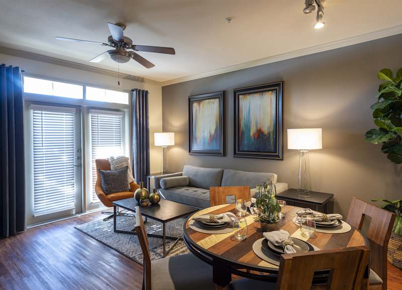 A dining table set for a meal, next to the living area