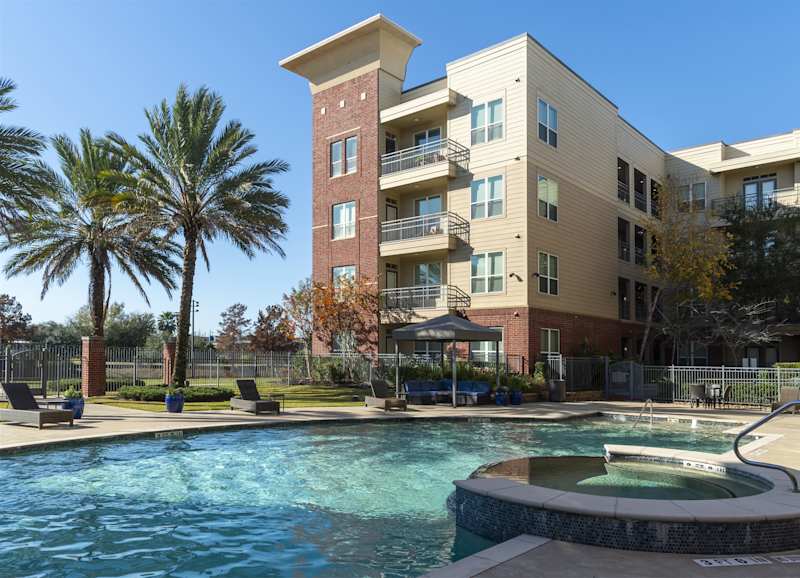 The pool in front of a multi-storey apartment building