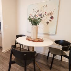 a kitchen with a table and chairs and a painting on the wall at The Crest at Acworth Apartments, Acworth, GA