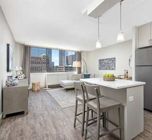 A modern kitchen with a dining table and chairs.