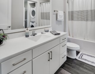Spacious Bathroom with White Cabinetry