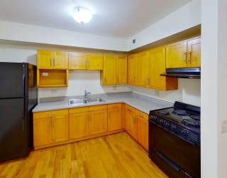a kitchen with wooden cabinets and black appliances