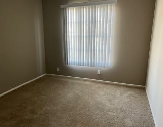a room with a window and a carpet