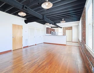 A room with wooden floors and white walls.