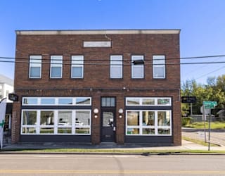 A brick building with a sign that says "Supreme" on it.