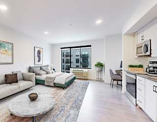 A modern living room with a grey sofa and a coffee table.