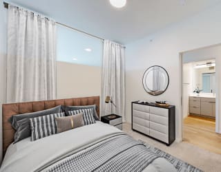 a bedroom with a large bed and a mirror