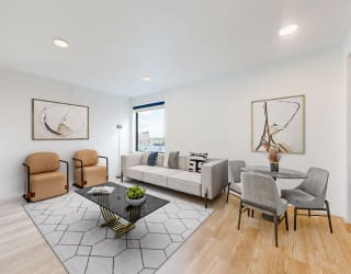 a living room with a couch and a table with chairs