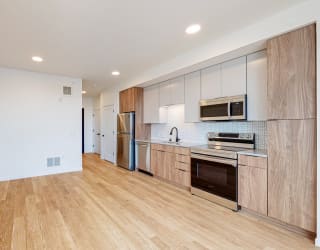 Modern Kitchen With Stainless Steel Appliances And Double Door Refrigerators at The Mason, St. Paul, MN