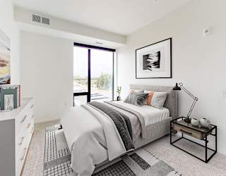a bedroom with a bed and a large window