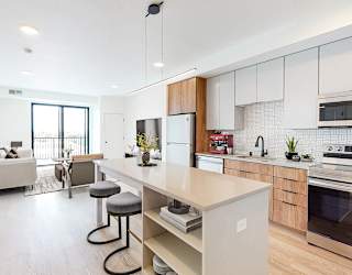 a kitchen with a large island and a living room